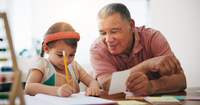 Child, senior man and education or writing, book and learning at home, drawing and support or paper. Girl, grandfather and notebook or tutoring, assessment and smile for language or math homework - Powered by Adobe