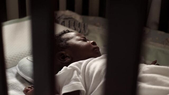 Closeup of little baby sleeping in the cradle. Shot film HD.