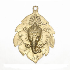 hindu god lord ganesha face antique sculpture on a leaf used as wall hanging display in gold isolated 