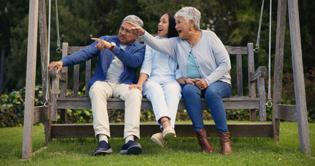 Father, senior or mother with woman on bench in nature pointing, talking or speaking in retirement....