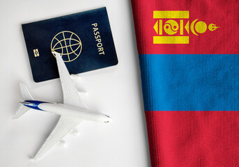  Flag of Mongolia with passport and toy airplane. Flight travel concept