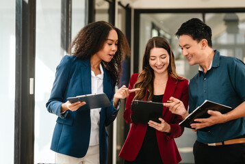 Professional team of caucasian and african american business women and asian man working together,...