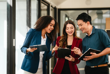 Professional team of caucasian and african american business women and asian man working together,...