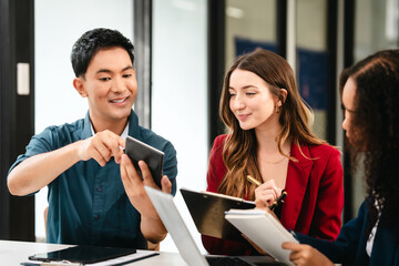 Diverse group of professionals engaging in discussion with laptop and clipboard, in bright office environment. qualified auditor report and opinion, asian people, african american, caucasian female