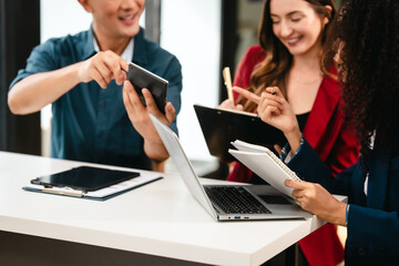 Diverse group of professionals engaging in discussion with laptop and clipboard, in bright office environment. qualified auditor report and opinion, asian people, african american, caucasian female