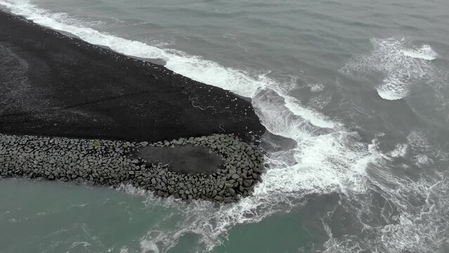 Aerial of where the sea meets glacier lagoon in Iceland near Diamond Beach. 