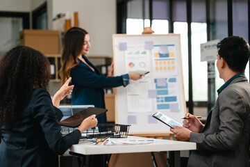 diverse team of professionals engaged in a website graphic design board meeting, sharing opinions on UX and UI design elements. Asian man, African American people, black, afro, caucasian female
