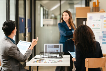 diverse team of professionals engaged in a website graphic design board meeting, sharing opinions on UX and UI design elements. Asian man, African American people, black, afro, caucasian female