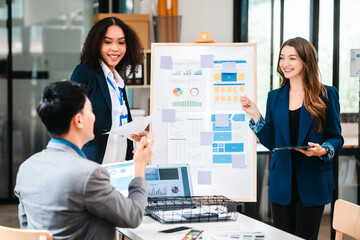 diverse team of professionals engaged in a website graphic design board meeting, sharing opinions on UX and UI design elements. Asian man, African American people, black, afro, caucasian female