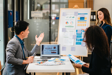 diverse team of professionals engaged in a website graphic design board meeting, sharing opinions on UX and UI design elements. Asian man, African American people, black, afro, caucasian female