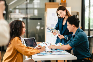 diverse team of professionals engaged in a website graphic design board meeting, sharing opinions on UX and UI design elements. Asian man, African American people, black, afro, caucasian female