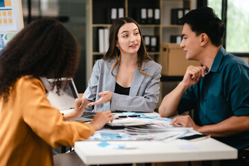 Obraz premium diverse team of professionals engaged in a website graphic design board meeting, sharing opinions on UX and UI design elements. Asian man, African American people, black, afro, caucasian female