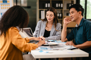 diverse team of professionals engaged in a website graphic design board meeting, sharing opinions on UX and UI design elements. Asian man, African American people, black, afro, caucasian female