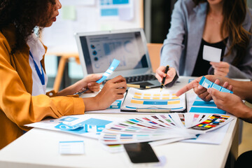 diverse team of professionals engaged in a website graphic design board meeting, sharing opinions on UX and UI design elements. Asian man, African American people, black, afro, caucasian female