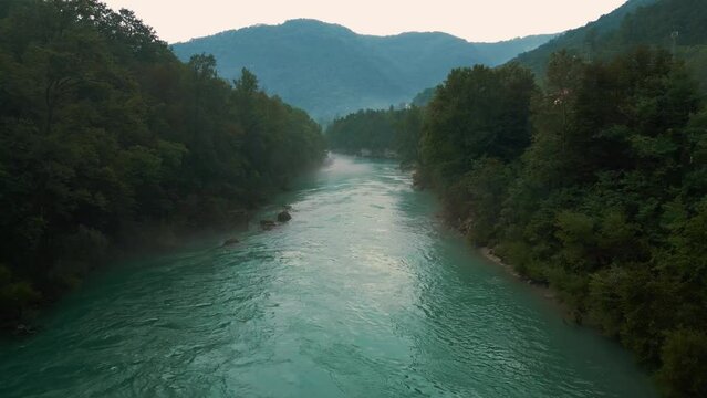 Soča Isonzo river with its iconic emerald blue water in the alps in Slovenia and Italy.