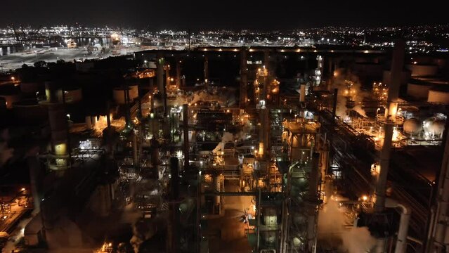 Oil refinery at nighttime - aerial flyover