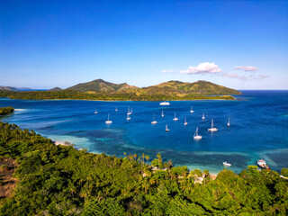 Boats moored of shore of Fijian tropical island. Nanuya island, Yasawa islands. 