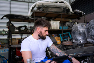 Fototapeta na wymiar Mechanic work at auto repair shop.