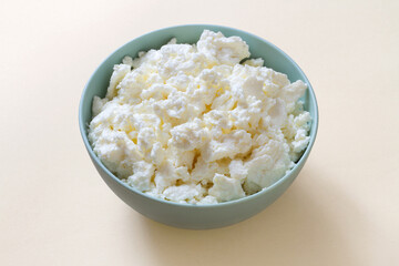 Natural milk cottage cheese in a plate. Organic fermented milk product. Fresh crumbly cottage cheese.