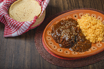 Mole, typical Mexican food. Traditional Mexican dish served in a clay dish.