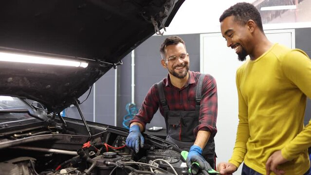 Mechanic Is Talking To The Customer About A Problem With The Car