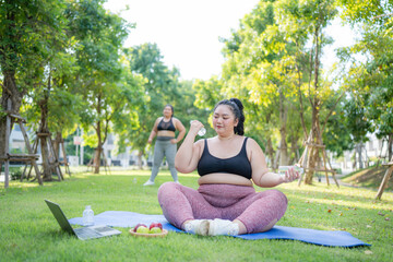 Happy plus size asian woman practicing yoga in garden. Healthy lifestyle and relaxation concept.Young Asian Girl doing yoga in the park.