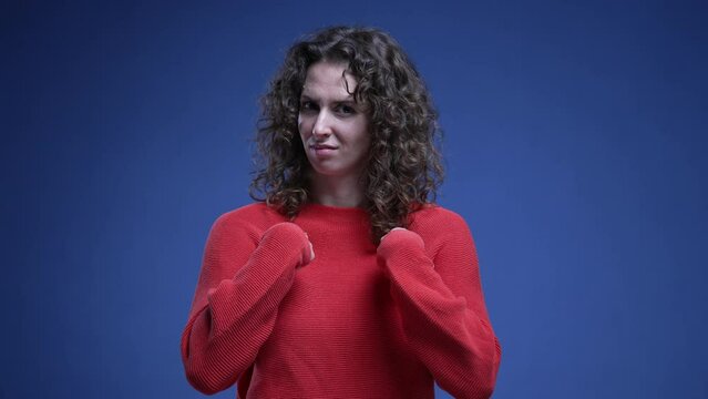 Baffled woman reacting to accusation with surprise, pointing finger to herself rejecting recrimination - waving finger "not me" body language
