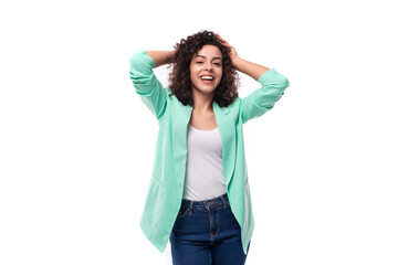 Obraz na płótnie Canvas young pretty curly brunette employee of a business company woman stylishly dressed in a jacket on a white background