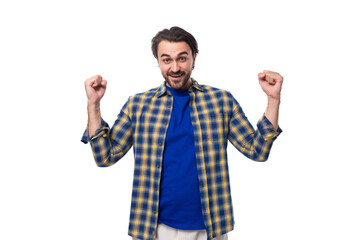 Naklejka premium portrait of a young european brunette with a beard waving his arms wide