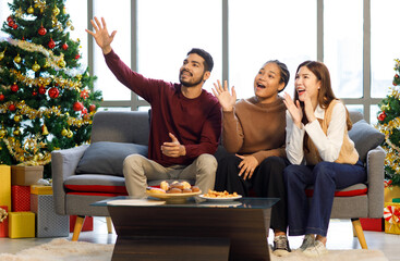 Millennial Asian Indian multinational cheerful male female friends celebrate Christmas Eve Happy...