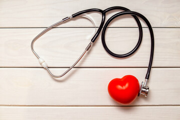 Red heart with stethoscope on white background
