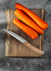 Carrots On Kitchen Wooden Board And Knife.