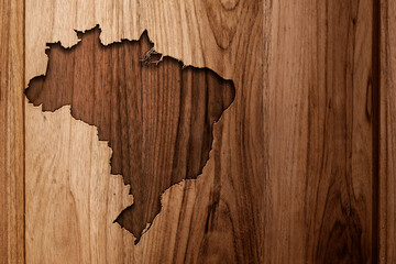 Map of Brazil carved into a wooden base or board with copy space for design. Wood texture engraved with the silhouette of a hand-crafted map of Brazil. Symbol. Panel. Rustic. Detailed.