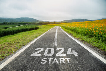 Happy new year 2024,2024 symbolizes the start of the new year. The letter start new year 2024 on the road in the nature route roadway have tree environment ecology or greenery wallpaper concept.