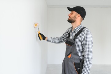 Young worker making repair in room.
