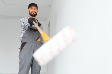 Young worker making repair in room.
