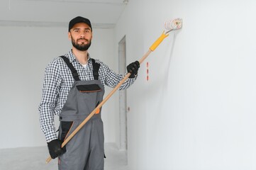 Young worker making repair in room.