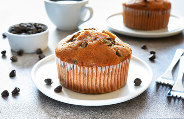 Muffin with chocolate chips and a cup of coffee. Morning and breakfast time.