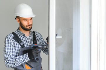 Construction worker installing window in house.
