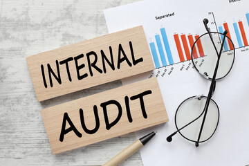 Internal audit paperwork documentation with pen, data and charts. Business improvement and quality management system concept.