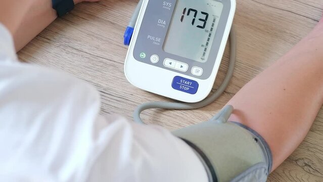 man check blood pressure monitor and heart rate monitor with digital pressure gauge. Health care and Medical concept	