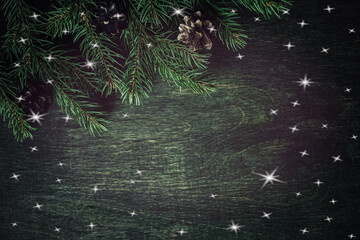 Christmas, New Year, festive, green background with spruce branches and white stars. Green wooden wall. A festive New Year or Christmas banner for advertising.