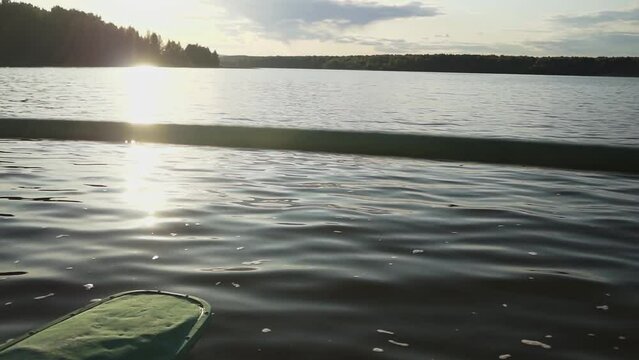 pond and catamaran. water close-up. slow motion video. sunset in summer. High-quality 4K shooting