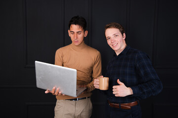 Two young attractive friends are communicating. Students posing in the studio.