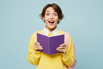Young shocked surprised woman student wears casual clothes yellow sweater backpack bag look camera...