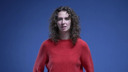 Woman celebrates with YES affirmation. 20s female person jumps with joy as she receives positive accomplishment