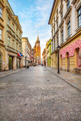 Naklejka na ściany i meble Old town street in Cracow, Poland with St. Mary's Basilica