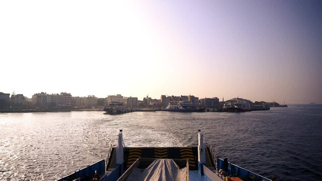 View of the city receding from the inside of the ship leaving the port
