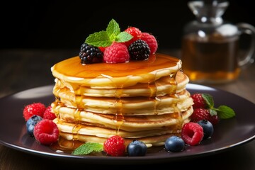 Stack of pancakes with syrup and berries