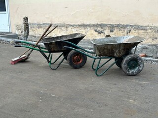 An old dirty cart for transporting garbage and construction materials